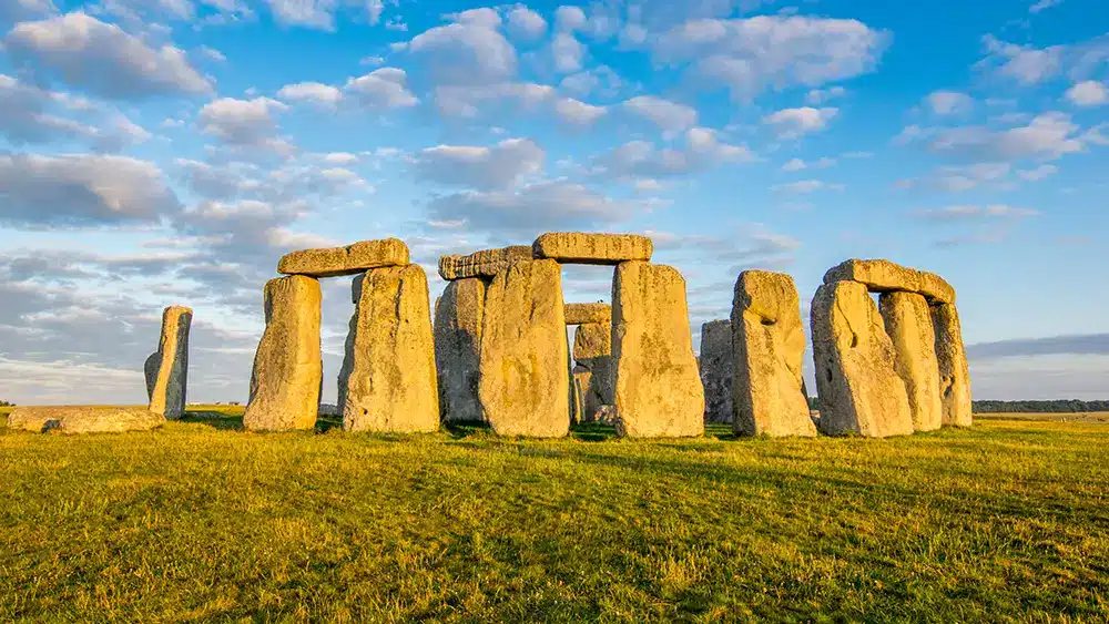 A photo of stonehenge - a ring of ancient stone pillars on a hilltop